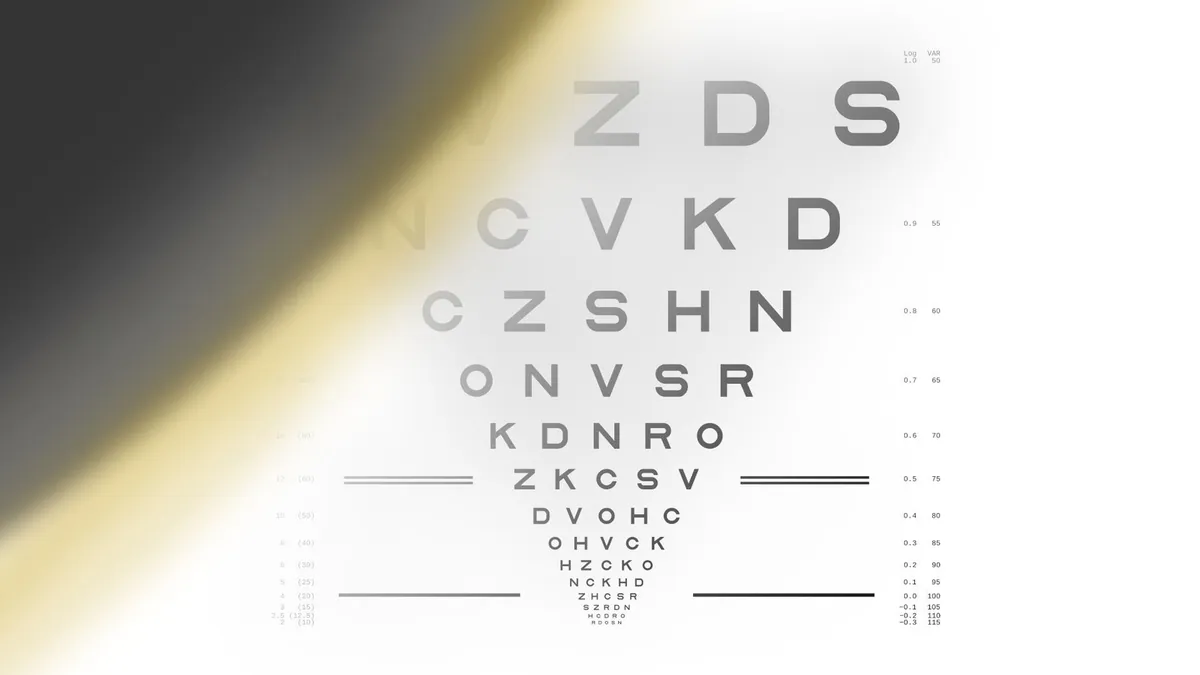 Tabela de letras para medir a visão, com uma grande sombra escura e borrada no canto superior esquerdo.